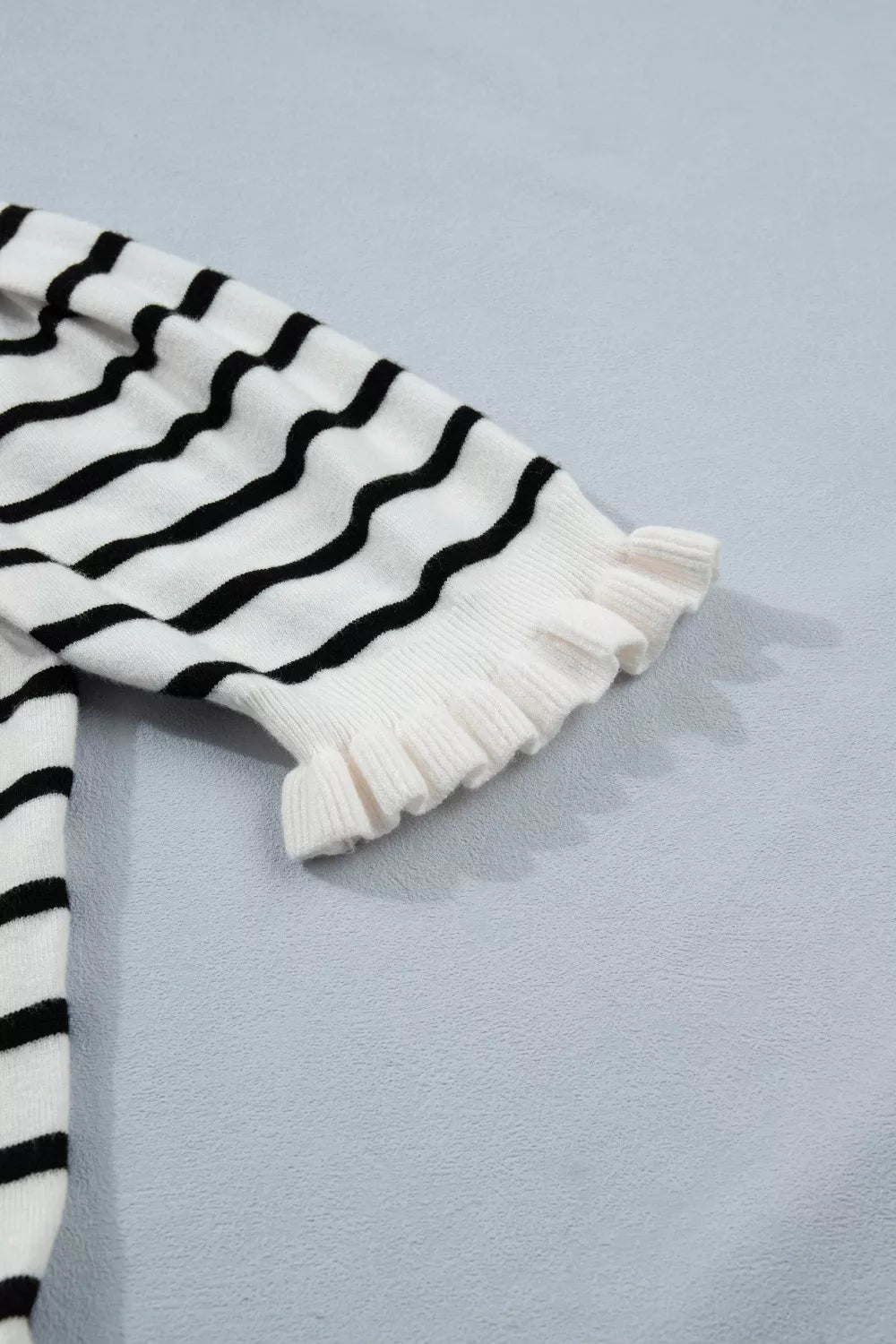 Chic striped maternity cardigan with ruffled cuffs and button detail.
