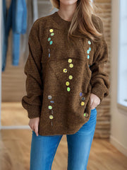 Brown knit sweater with scattered geometric sequin embellishments.