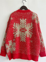 Red acrylic sweater with glitter snowflake pattern and crew neck.