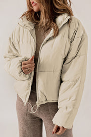 Cream cropped puffer jacket with hood, full zip, and drawstring hem.