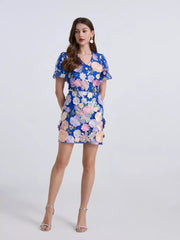 Royal blue mini dress with puff sleeves and embroidered floral appliques.