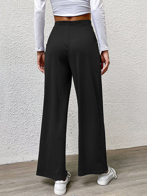 Black wide leg trousers with pleated front detail and a relaxed fit.