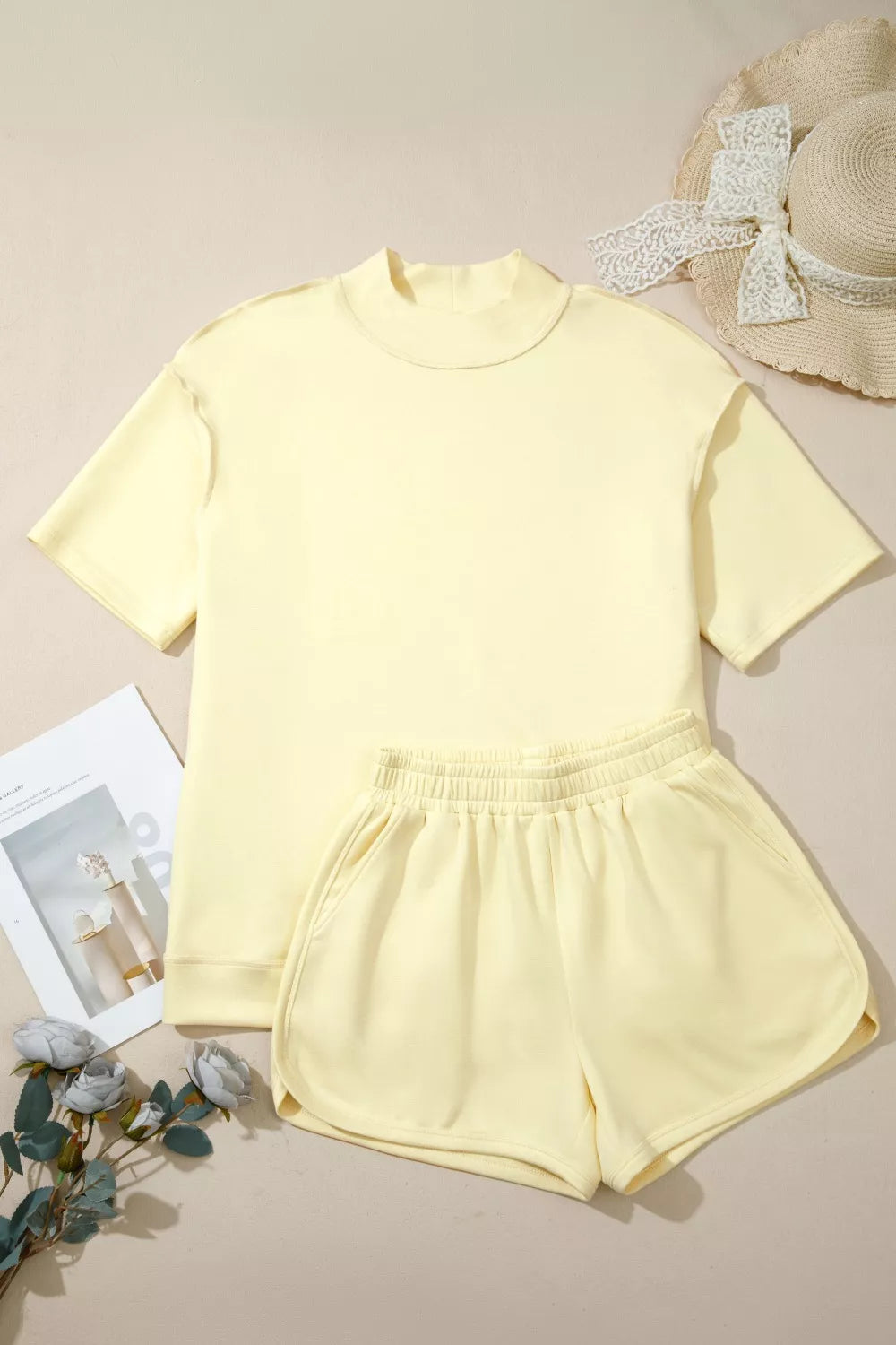 Yellow mock neck t-shirt and dolphin shorts set with dropped shoulders and elastic waistband.