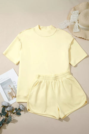 Yellow mock neck t-shirt and dolphin shorts set with dropped shoulders and elastic waistband.