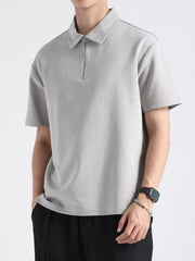 Light gray cotton zippered polo shirt for men with short sleeves and a spread collar.