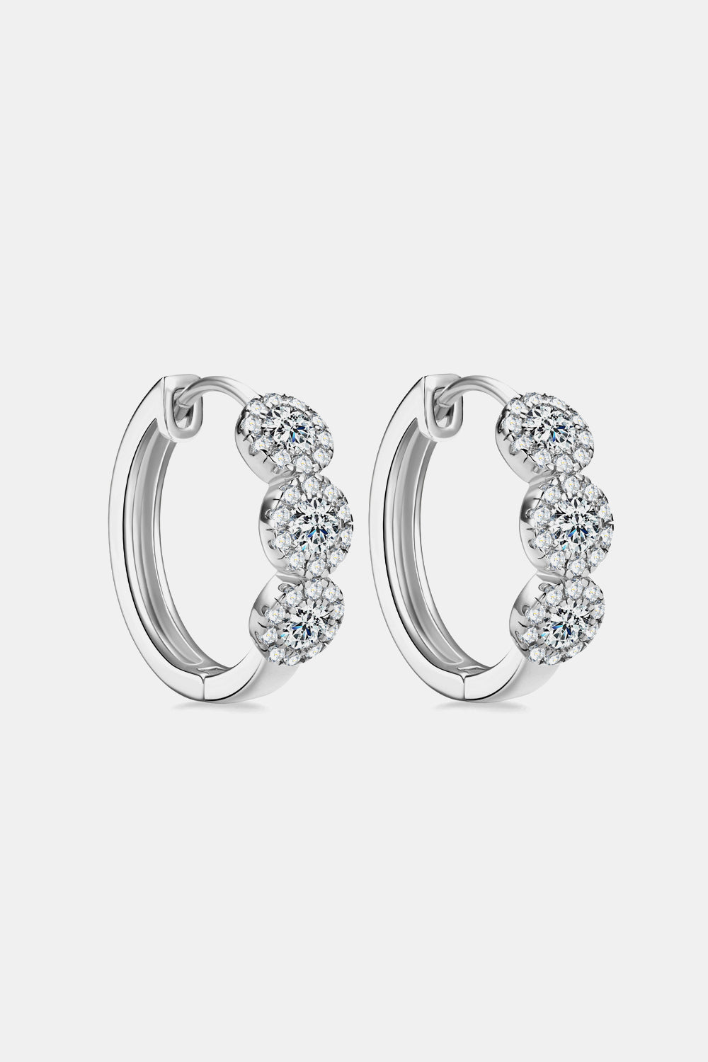 Silver triple cluster diamond huggie hoop earrings with sparkling cubic zirconia.