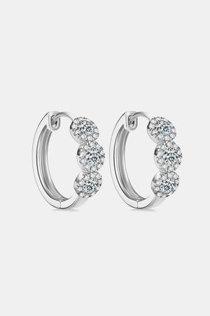 Silver triple cluster diamond huggie hoop earrings with sparkling cubic zirconia.