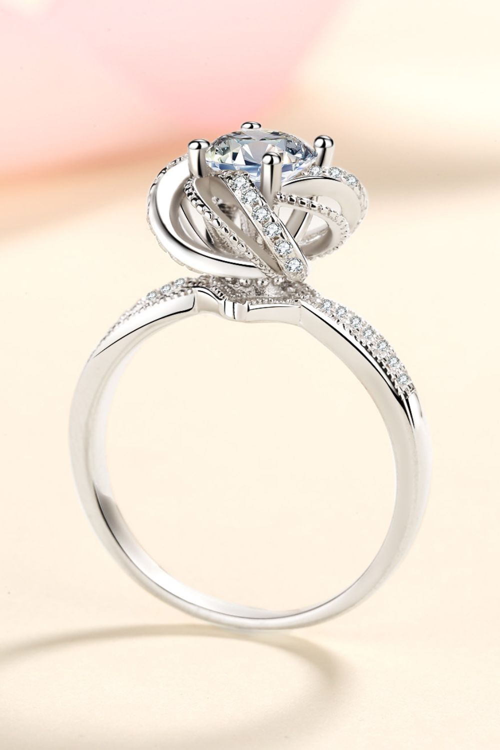 Silver halo ring with moissanite and pavé details.