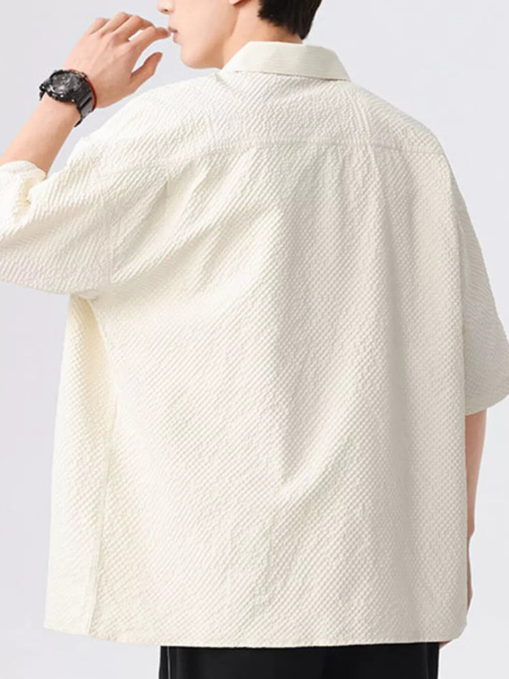 Men's textured beige short-sleeve shirt with a collared neckline.