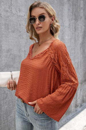 Orange-red blouse with lace sleeves and scallop trim, V-neck, long bell sleeves.