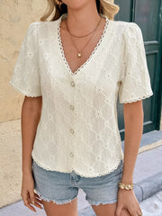 Textured white button-up maternity shirt with lace trim and short puff sleeves.