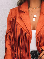 Orange suede cropped jacket with fringe detail and open front, styled with layered necklaces.