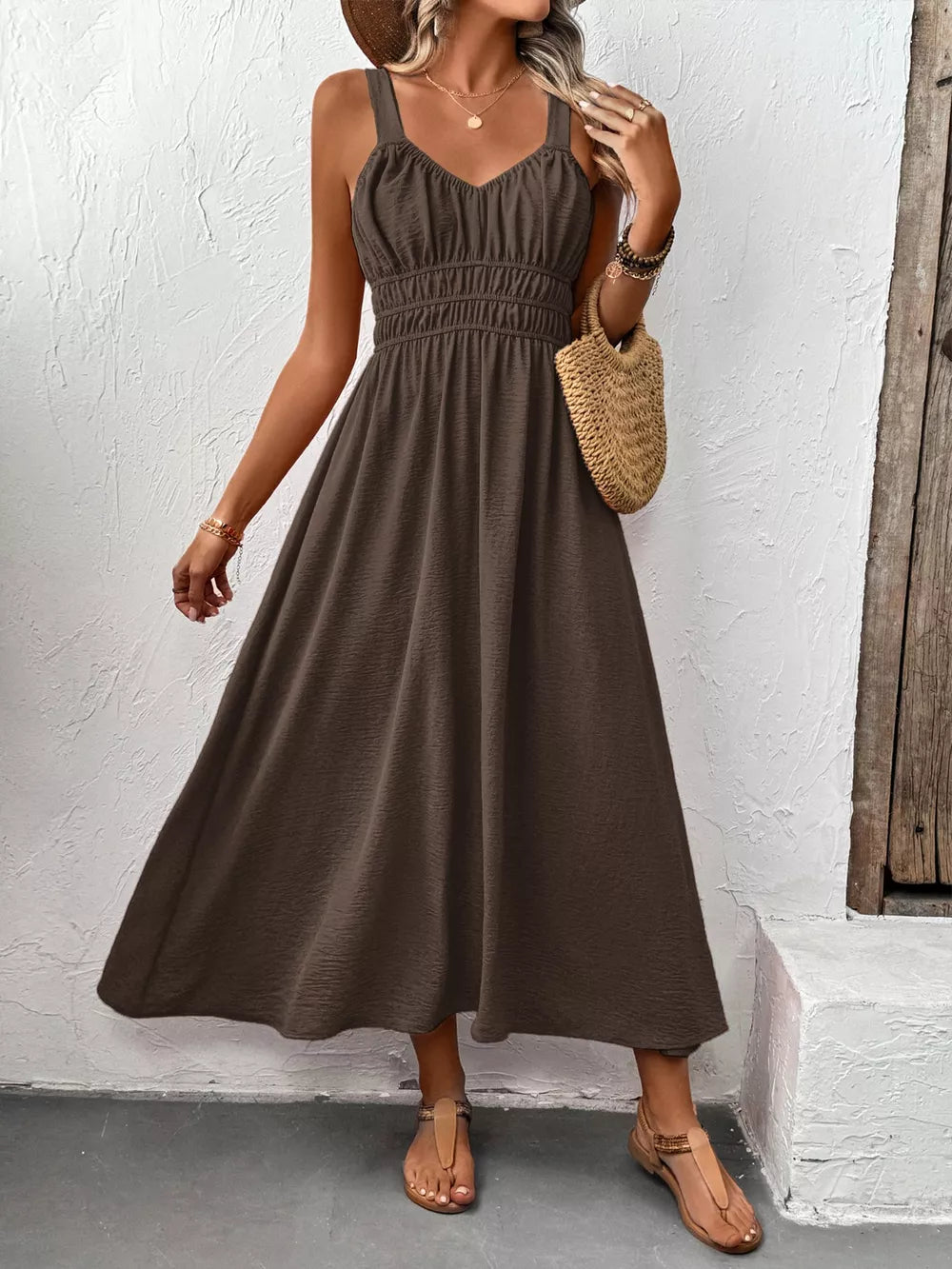Coffee brown smocked V-neck midi dress with a flowy skirt and spaghetti straps.