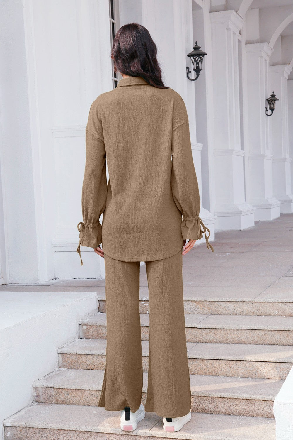 Textured tie-sleeve co-ord set in tan with wide-leg pants and split hem.