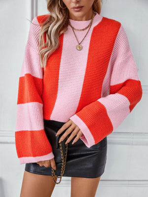 Colorblock stripe knit sweater in pink and orange with a crew neck and long sleeves.