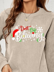 Beige corduroy crewneck sweatshirt with a Christmas graphic that says Dont Stop Believing.