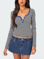 Striped long sleeve henley shirt with contrast royal blue collar and button placket.
