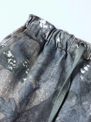 Men's camouflage cargo sweatpants with drawstring waist and metal eyelet detail.