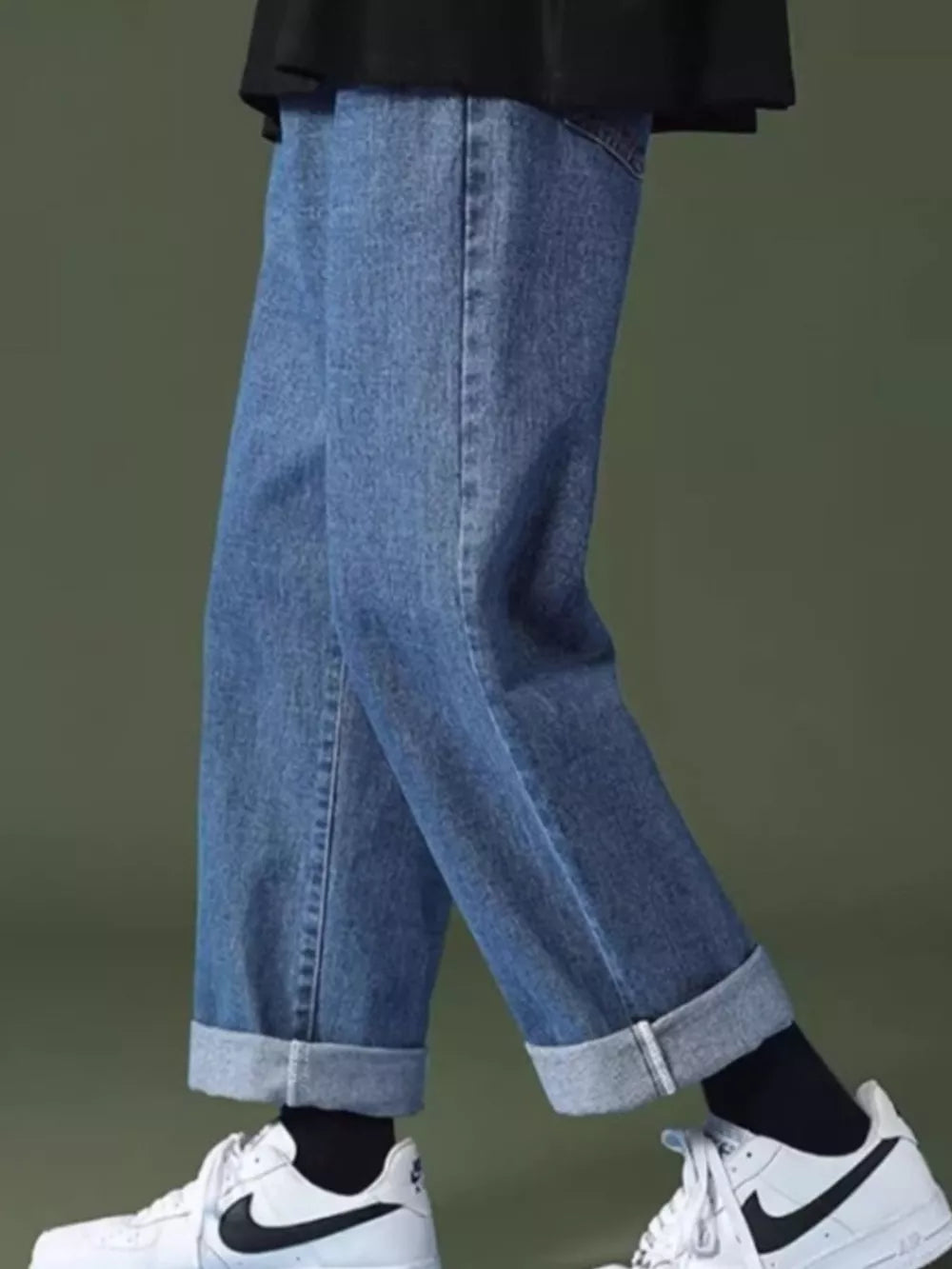 Men's casual wide-leg jeans in light wash denim with cuffed hems.