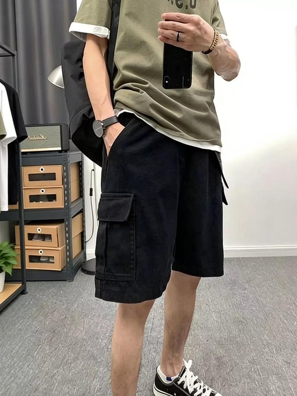 Men's black cotton cargo shorts with multiple pockets.