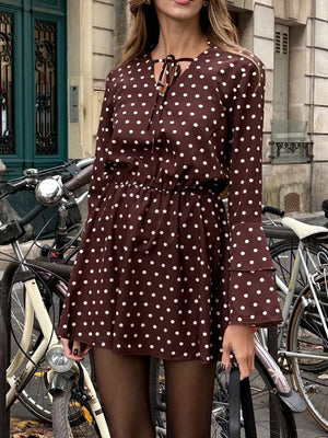 Brown polka dot mini dress with V-neck tie detail and tiered bell sleeves.