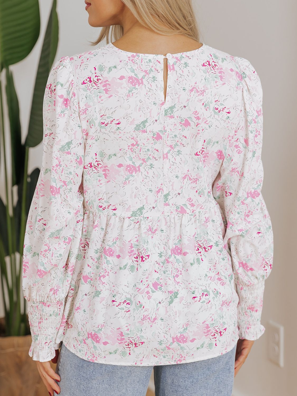 Blush pink floral print blouse with smocked waist and cuffs, puff sleeves.