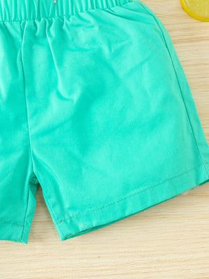 Turquoise cotton baby shorts with elastic waistband and dinosaur print detail.
