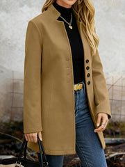 Khaki longline trench coat with button-down detail and collarless neckline.