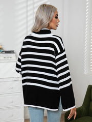 Black and white striped turtleneck sweater with flared sleeves and a relaxed fit.