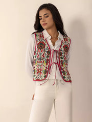 Embroidered tie-front cropped vest coat in deep red with floral pattern, worn over a white shirt.