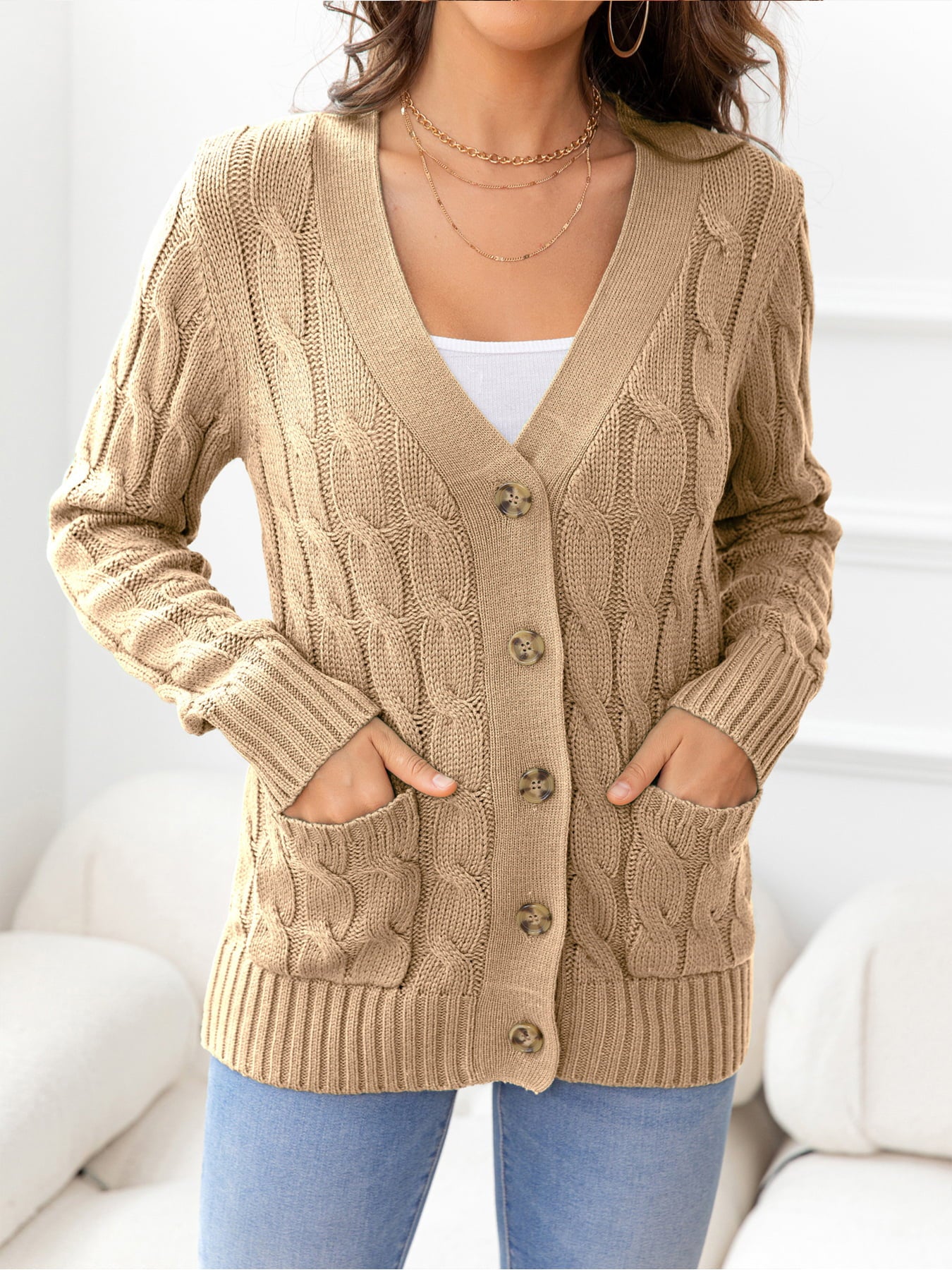 Camel cable-knit cardigan with V-neck, buttons, and pockets.