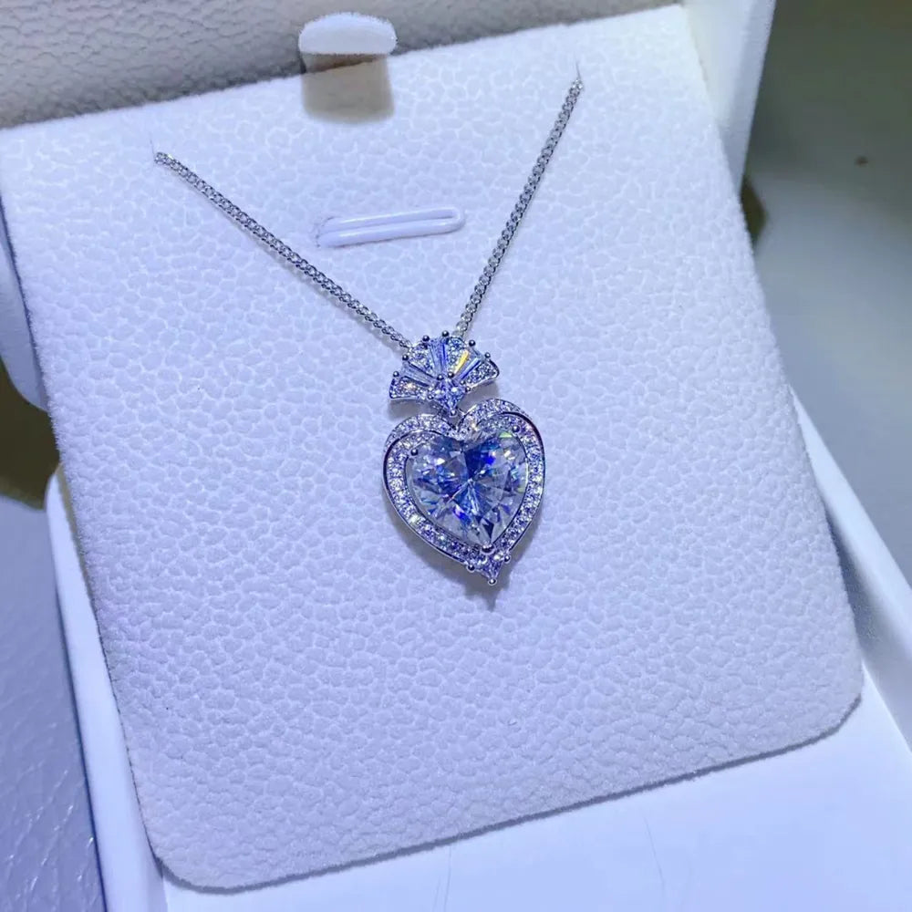 Silver moissanite heart halo pendant necklace with certificate on chain.