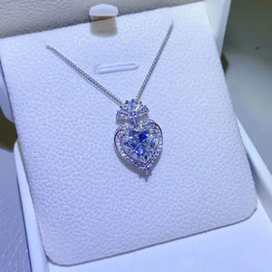 Silver moissanite heart halo pendant necklace with certificate on chain.