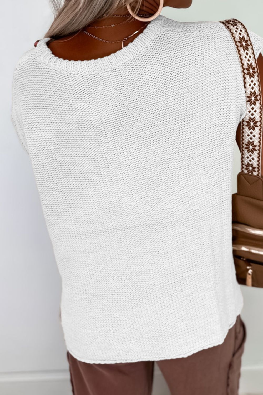 White boxy knit crop top with crew neck and short sleeves.
