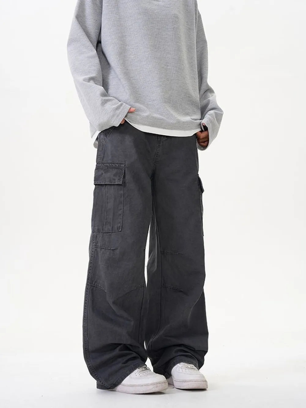 Grey cargo pants with versatile pockets and a relaxed fit.
