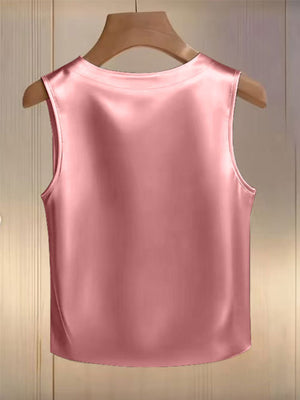Pink satin tank top with pearl embellishments, crew neck, sleeveless.