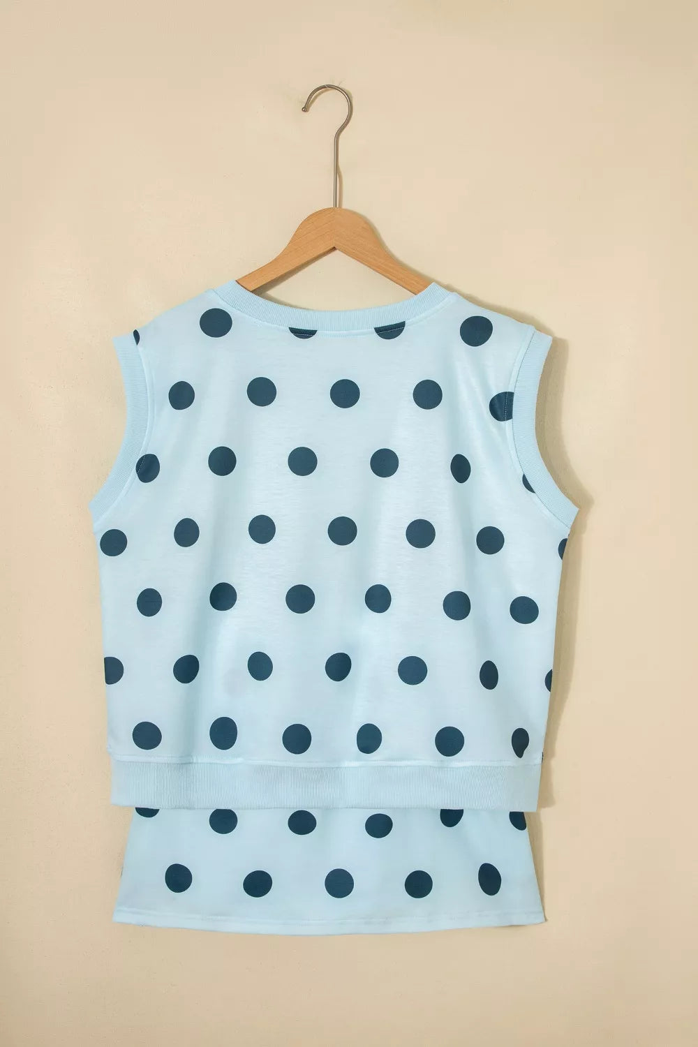 Pastel blue polka dot two-piece set with crew neck sleeveless top and skort.