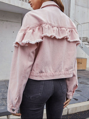 Blush pink denim trucker jacket with frayed ruffle detail across the back yoke.