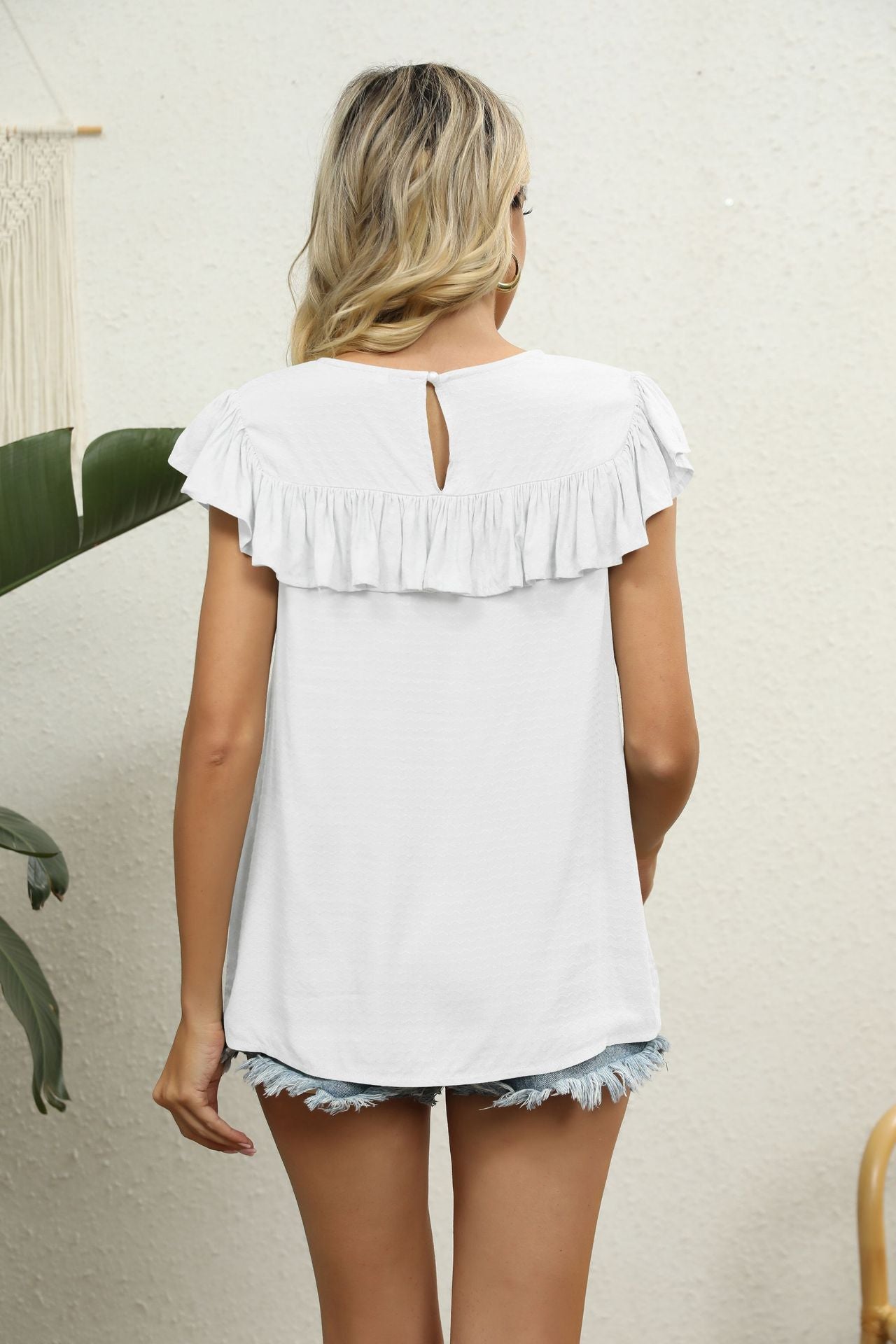 White lace yoke ruffle sleeve blouse with keyhole back detail.