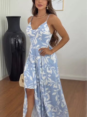 Light blue spaghetti strap maxi dress with white leaf print, V-neck, and high-low hem.