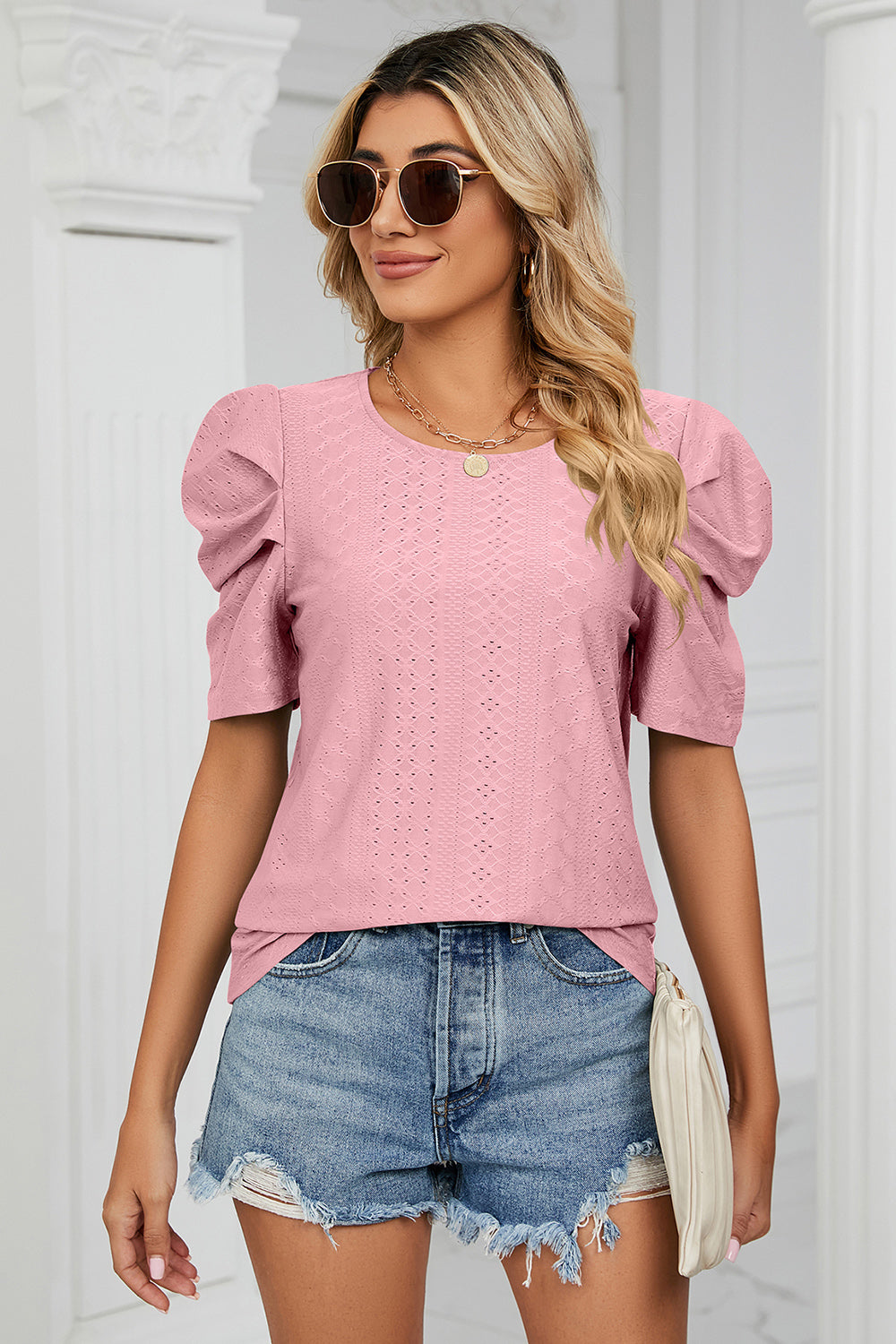 Perforated puff sleeve top in blush pink with a diamond pattern.