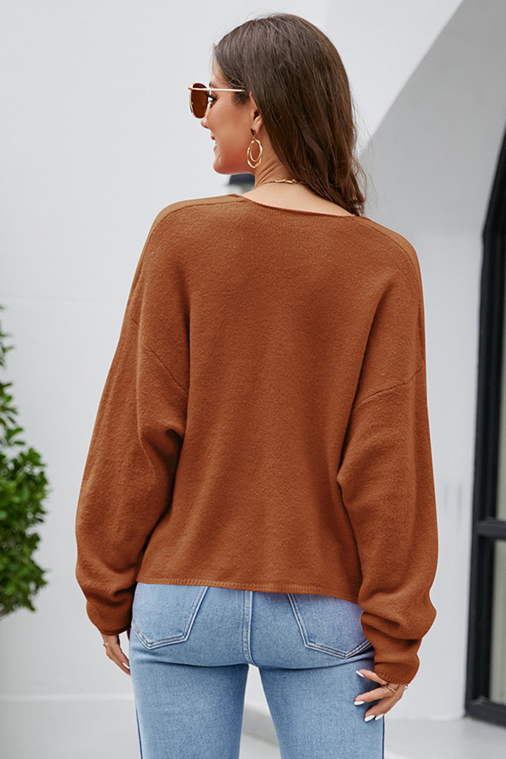 Caramel fluffy knit sweater with plunging neckline and long sleeves.