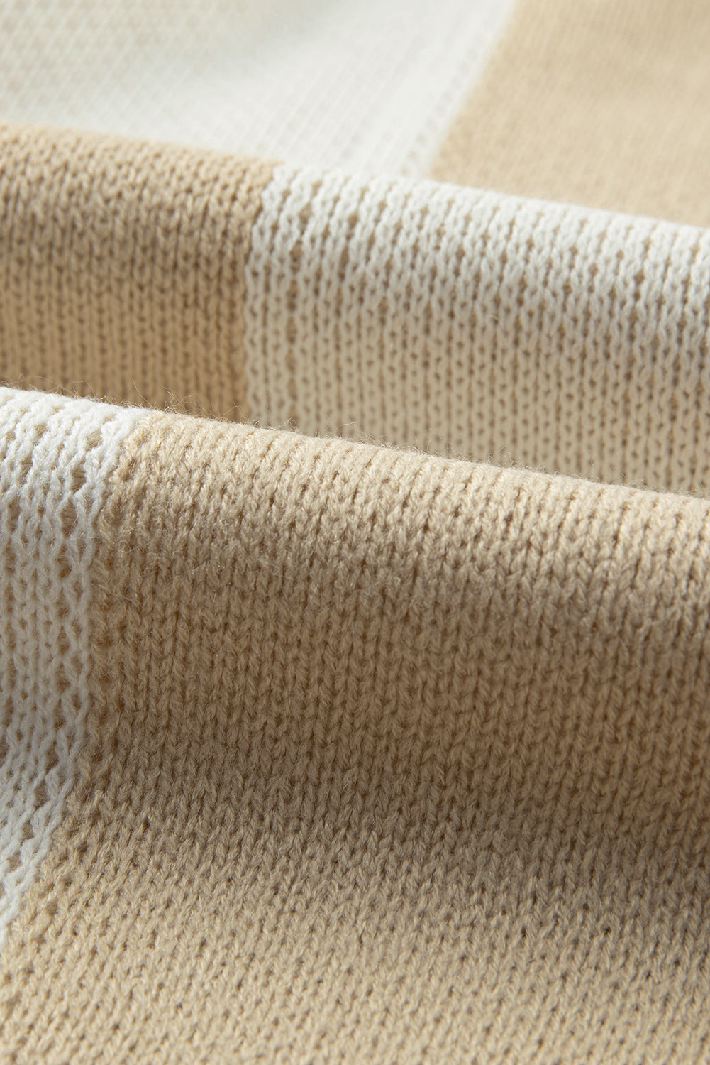 Colorblock checkerboard knit sweater in beige and cream acrylic fabric.