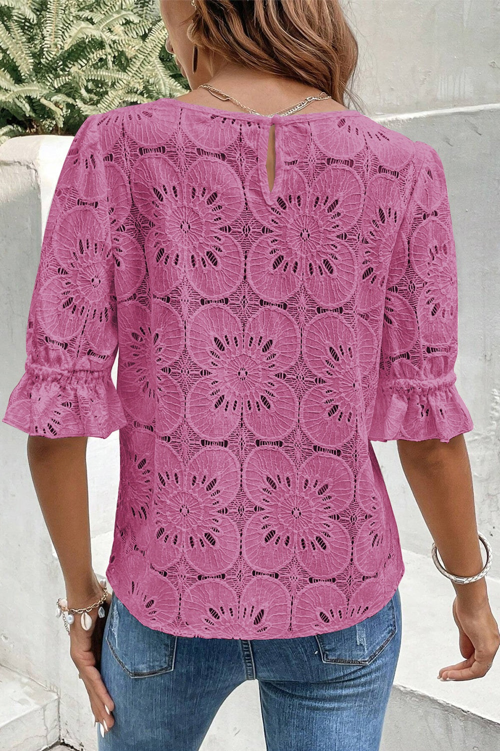 Red-violet floral eyelet blouse with puff sleeves and ruffled cuffs.