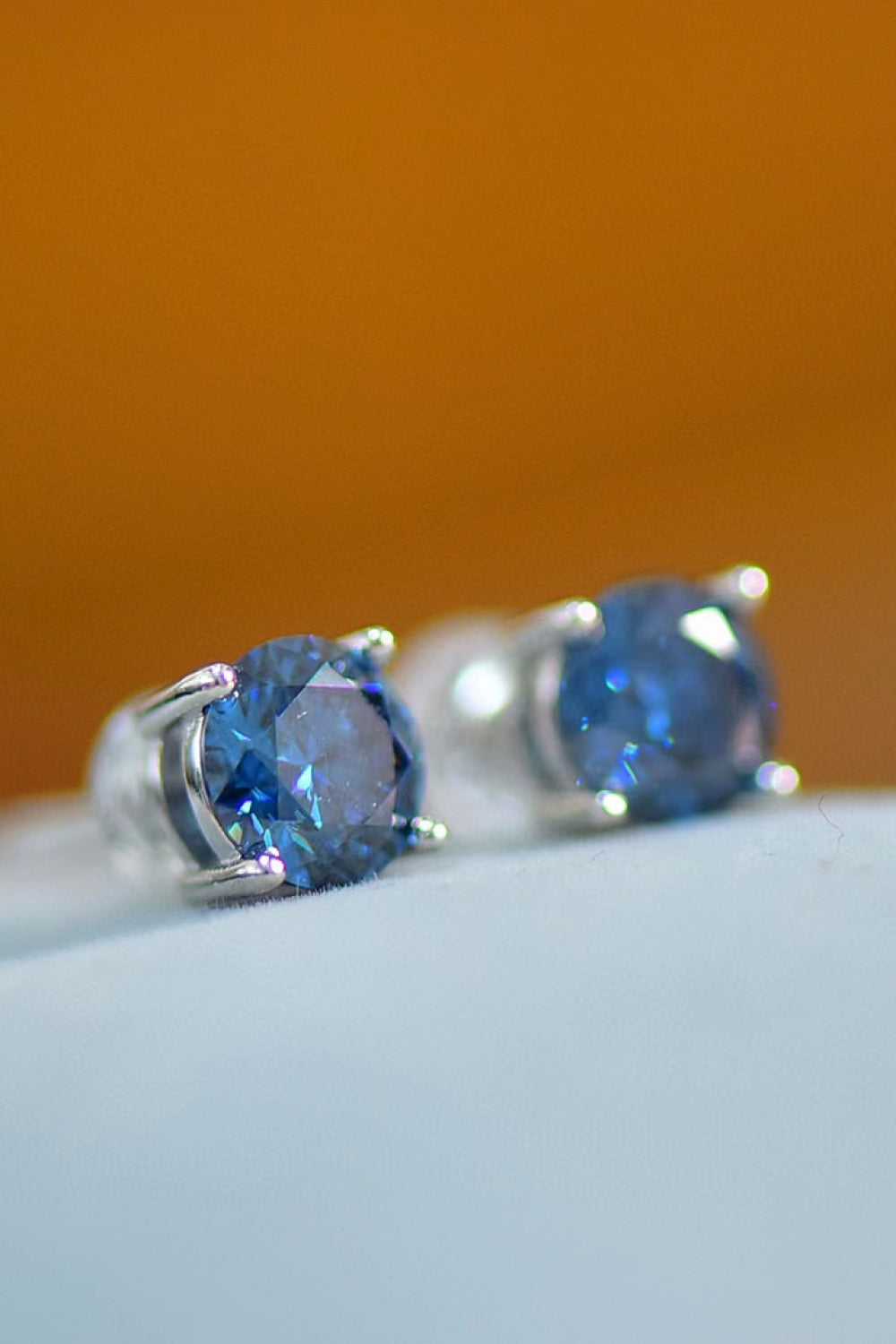 Sapphire Brilliance Platinum Stud Earrings with round blue stones.