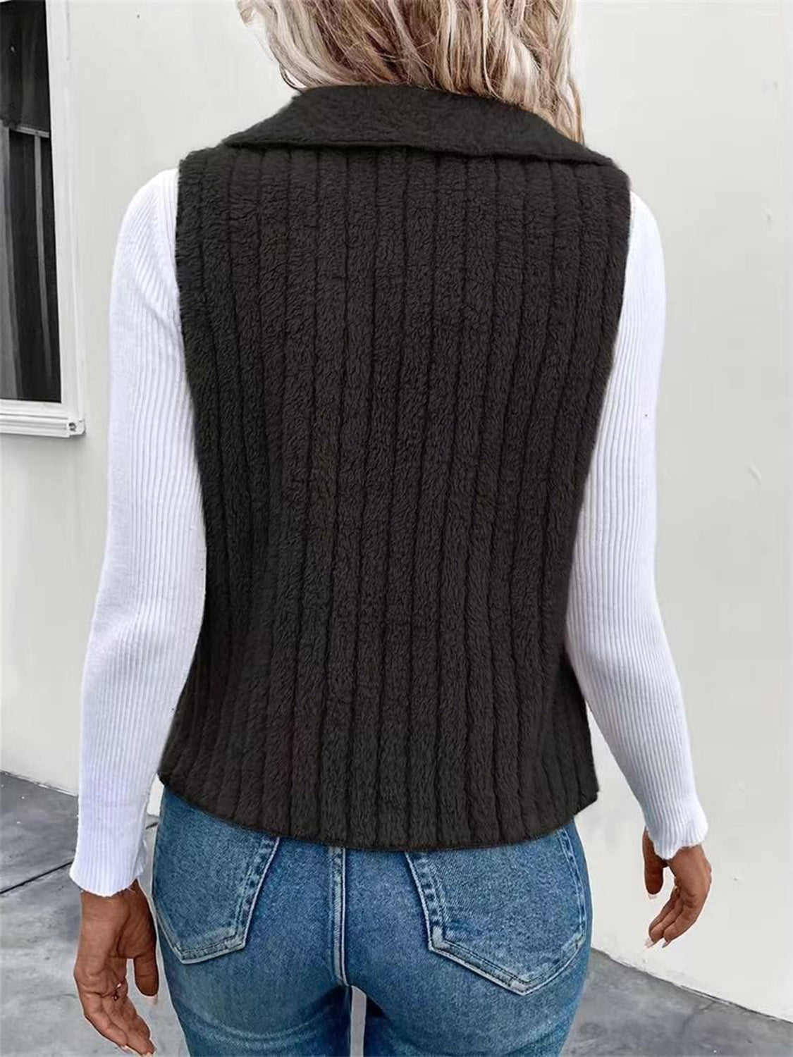 Textured teddy collarless vest in black with vertical ribbing detail.