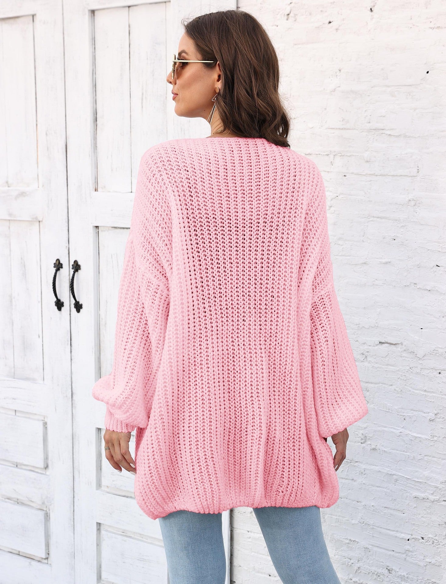 Blush pink balloon sleeve knit cardigan with ribbed texture and pearl buttons.