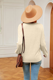 Relaxed knit sweater in pastel yellow with V-neck and lace trim detail.