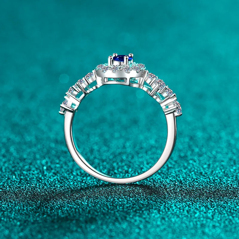 Silver sapphire halo ring with diamond cluster band in sterling silver.