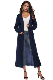 Longline dark blue knit cardigan with side slits and pockets, open front.